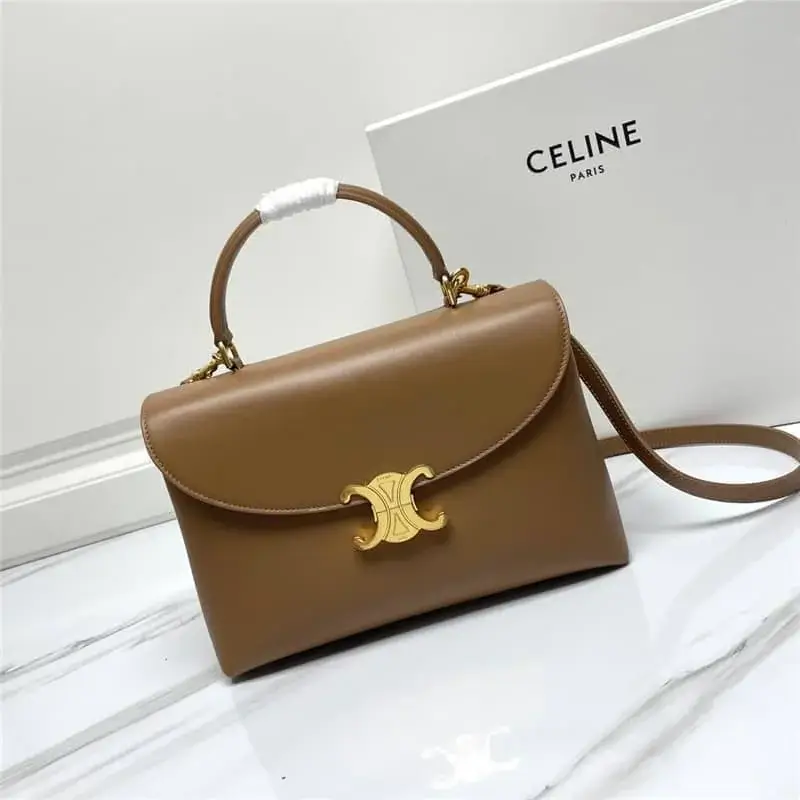 A classic COACH tote bag featuring a dark brown signature monogram leather, adorned with a gold chain detail and elegant charms including floral and diamond-shaped pendants, combining timeless elegance with modern style for everyday wear or casual outings.