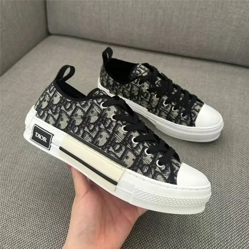 A sleek and stylish Prada low-top sneaker featuring a white and light blue color-block design, with a metallic triangular logo on the side and “PRADA” branding on the heel and midsole, exuding a clean, elegant look with premium craftsmanship.