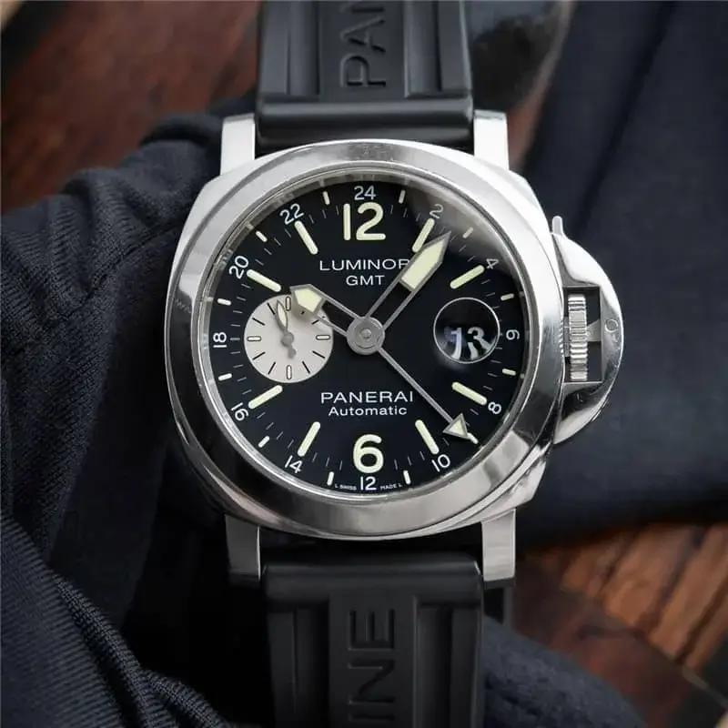 A Breitling Endurance series chronograph watch featuring a black ceramic case and rubber strap, with a black dial accented by orange details. The bezel includes cardinal direction markings (N, E, S, W), and the watch is equipped with a three-register chronograph, tachymeter, and pulsometer scales, designed for durability and performance in sports and adventure settings.